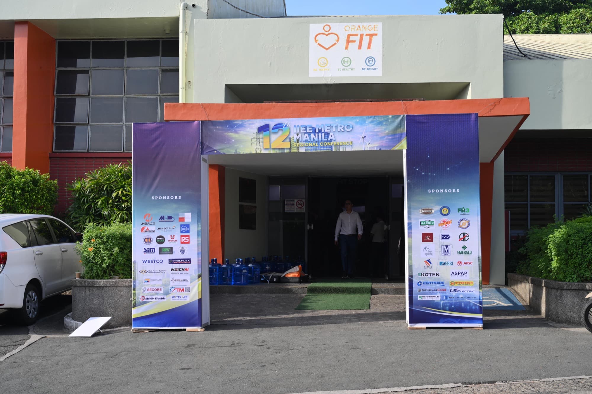 Venue entrance flanked by sponsor pull-up banners